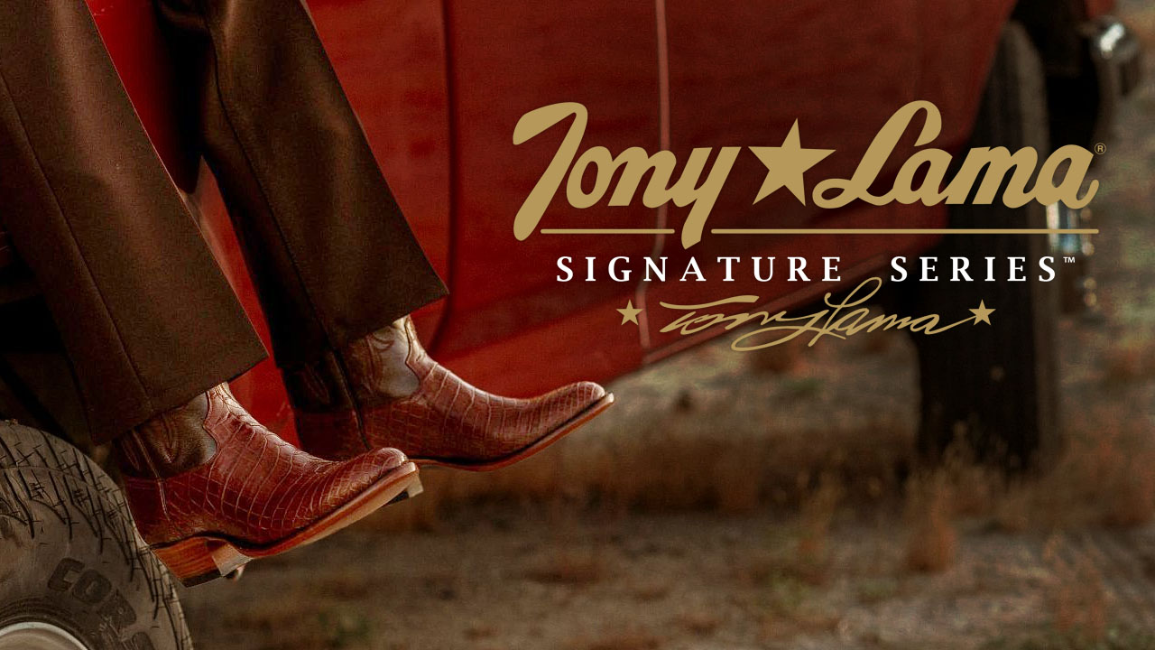 A man wearing a pair of Signature Series boots sitting on a red truck.